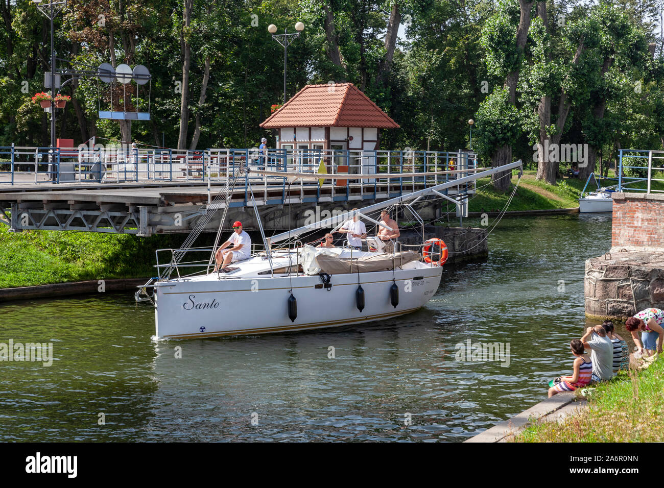 Gizycko, the sailboat flows under the historic open swing bridge on the Gizycko Channel, Poland Stock Photo