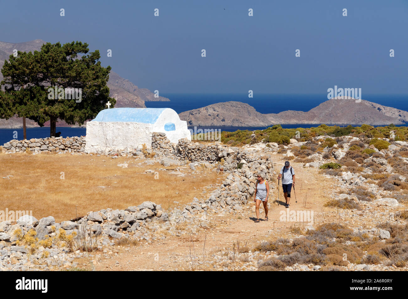 Walkers, Aghios Ioannis church, livadia, Tilos, Dodecanese islands, Southern Aegean, Greece. Stock Photo