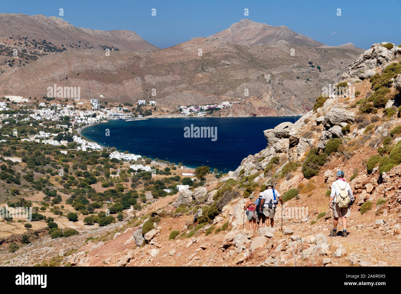 Walkers on path leading towards Livadia from Aghios Pavlos, Tilos, Dodecanese islands, Southern Aegean, Greece. Stock Photo