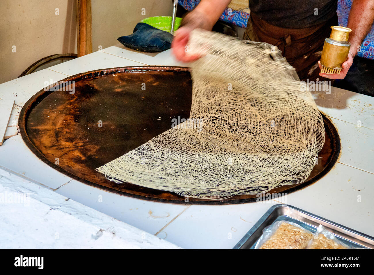 A man prepares the dough for the Guba Bukmasi, a traditional sweet from the Quba region of Azerbaijan Stock Photo