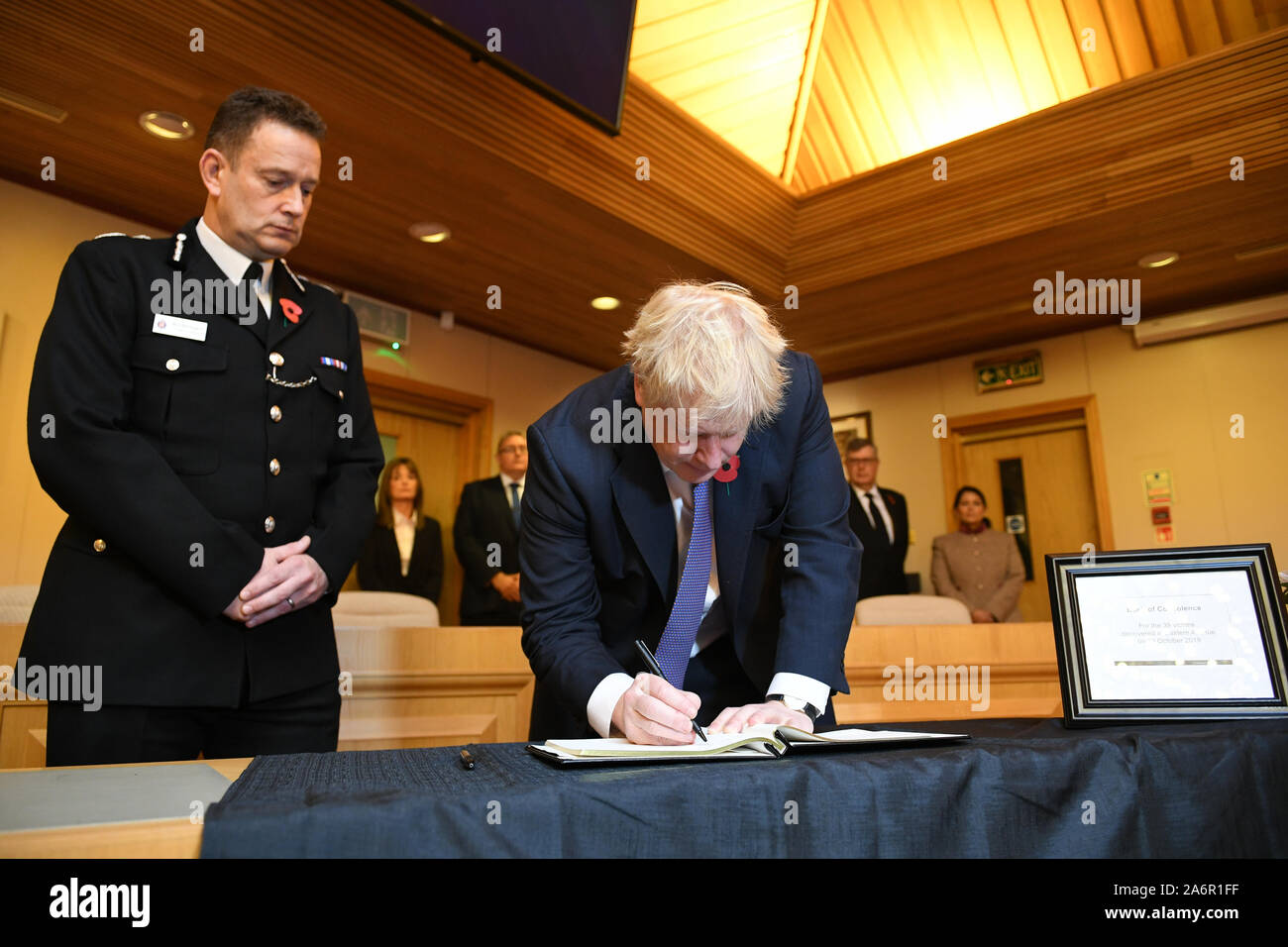 Prime Minister Boris Johnson signs a book of condolence during a visit to Thurrock Council Offices in Essex after the bodies of 39 people were found in a lorry container last week. Stock Photo
