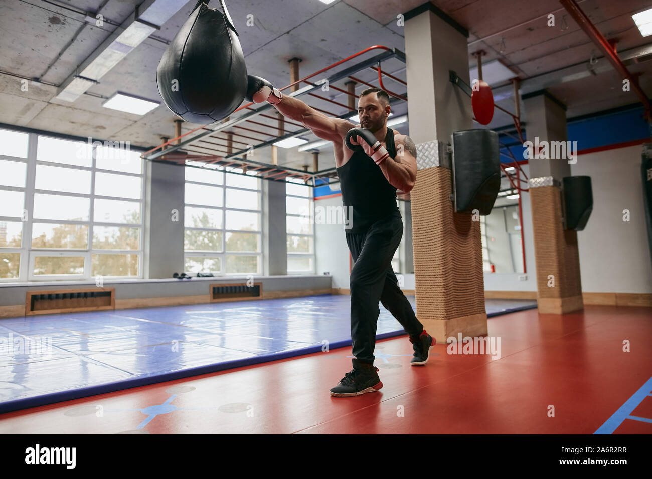 motivated guy training with punching speed ball.free time. spare time. motivatiob, health and body care, full length photo Stock Photo