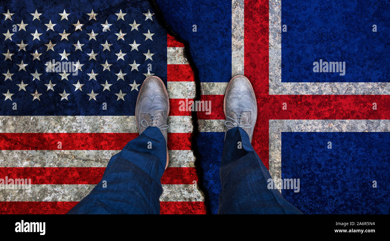 Business man stands on cracked flags of USA and Iceland. Political concept Stock Photo