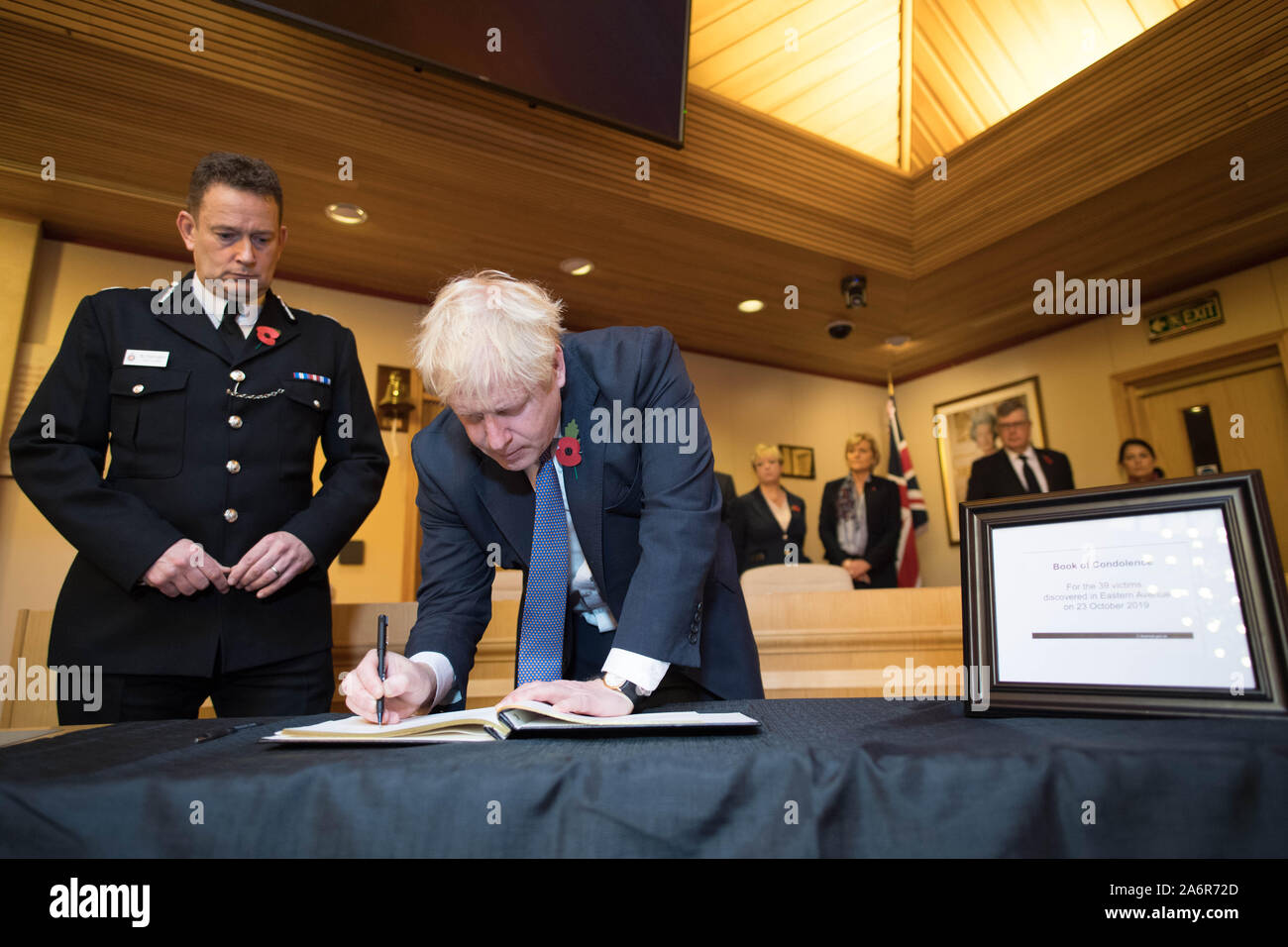 Prime Minister Boris Johnson signs a book of condolence, watched by the Chief Constable of Essex Police, Ben-Julian Harrington, during a visit to Thurrock Council Offices in Essex after the bodies of 39 people were found in a lorry container last week. Stock Photo