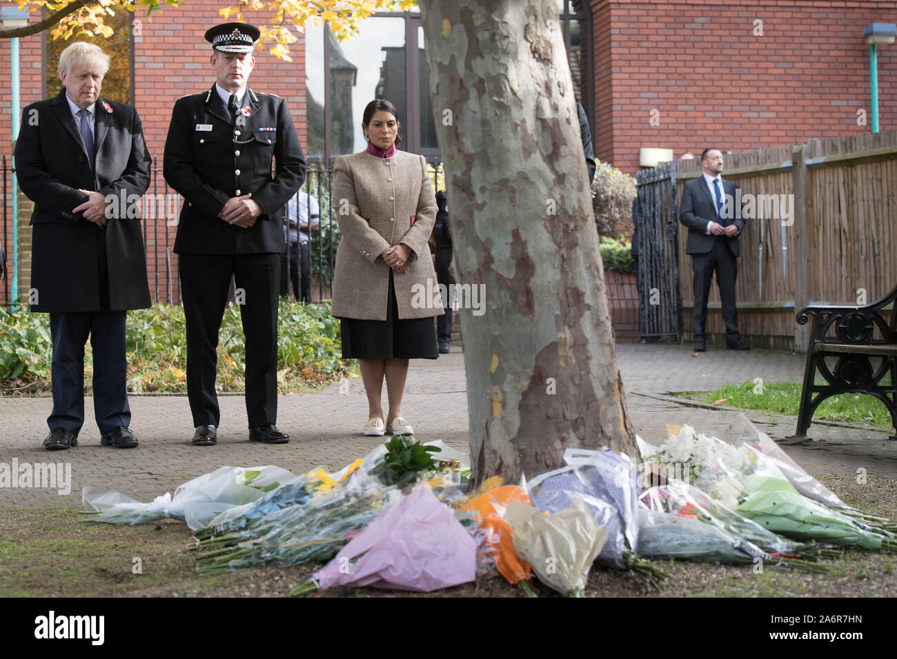 Prime Minister Boris Johnson stands with the Chief Constable of Essex Police, Ben-Julian Harrington and Home Secretary Priti Patel, after laying flowers during a visit to Thurrock Council Offices in Essex after the bodies of 39 people were found in a lorry container last week. Stock Photo