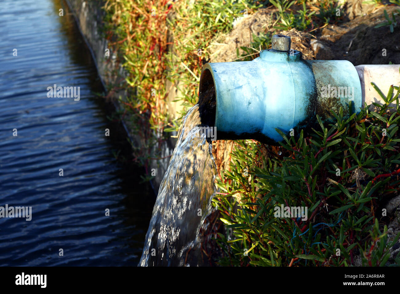 Photo of water rushing out of big pipe Stock Photo - Alamy