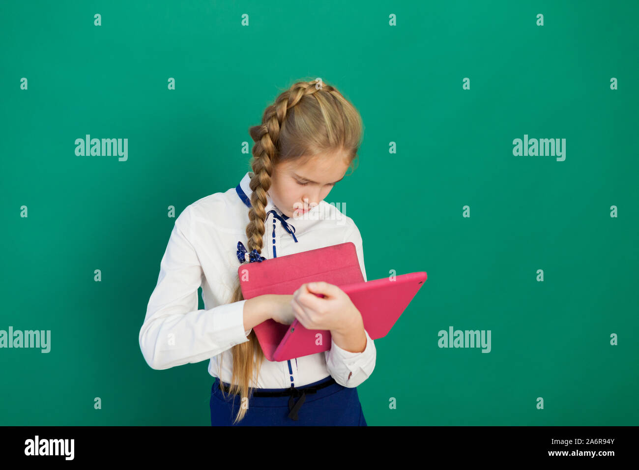 schoolgirl with internet tablet in class class Stock Photo