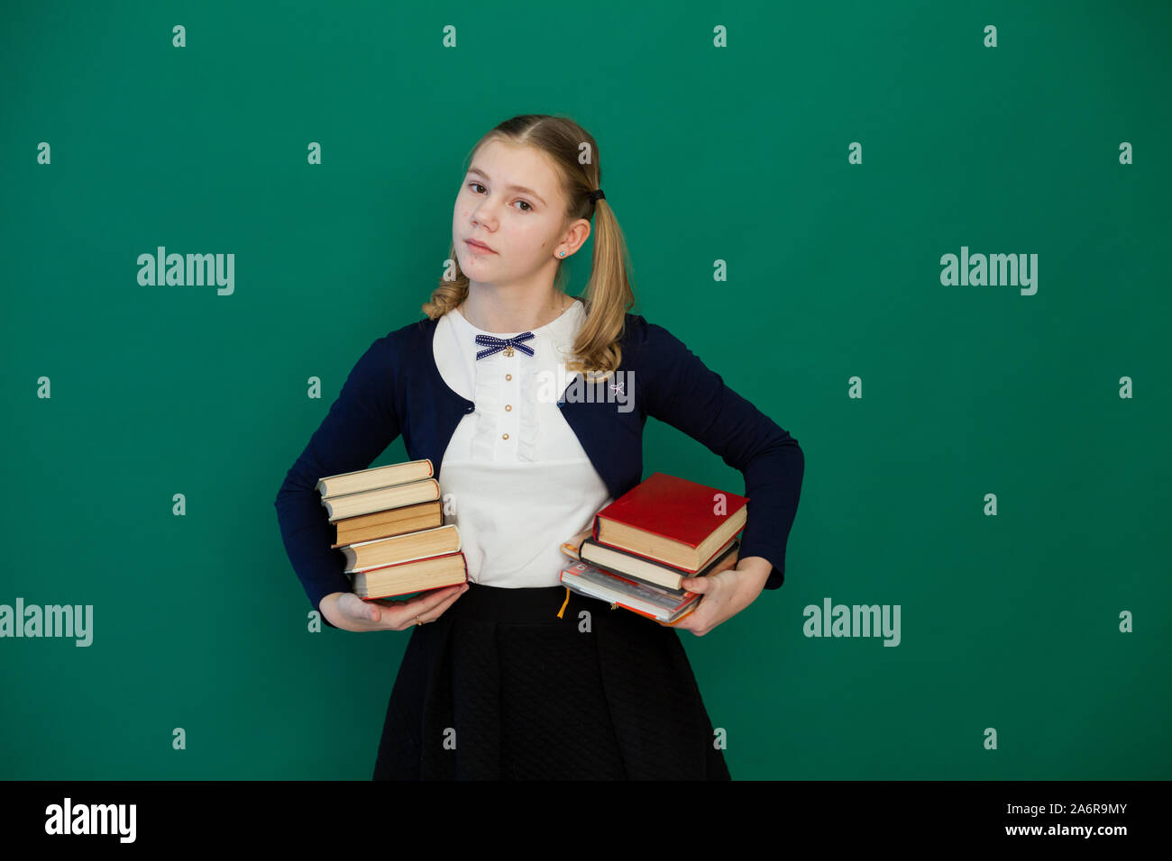 Schoolgirl schoolgirl with books in class in class Stock Photo - Alamy