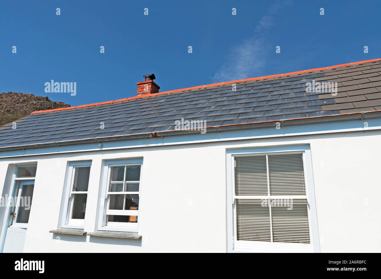 solar tiles photovoltaic tile on a home house roof Stock Photo