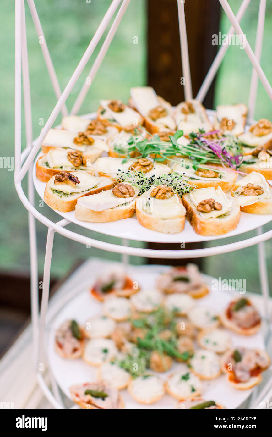 Mini canapes food. Beautiful decorated catering banquet, wooden stands.  Snacks and appetizers. Wedding celebration Stock Photo - Alamy