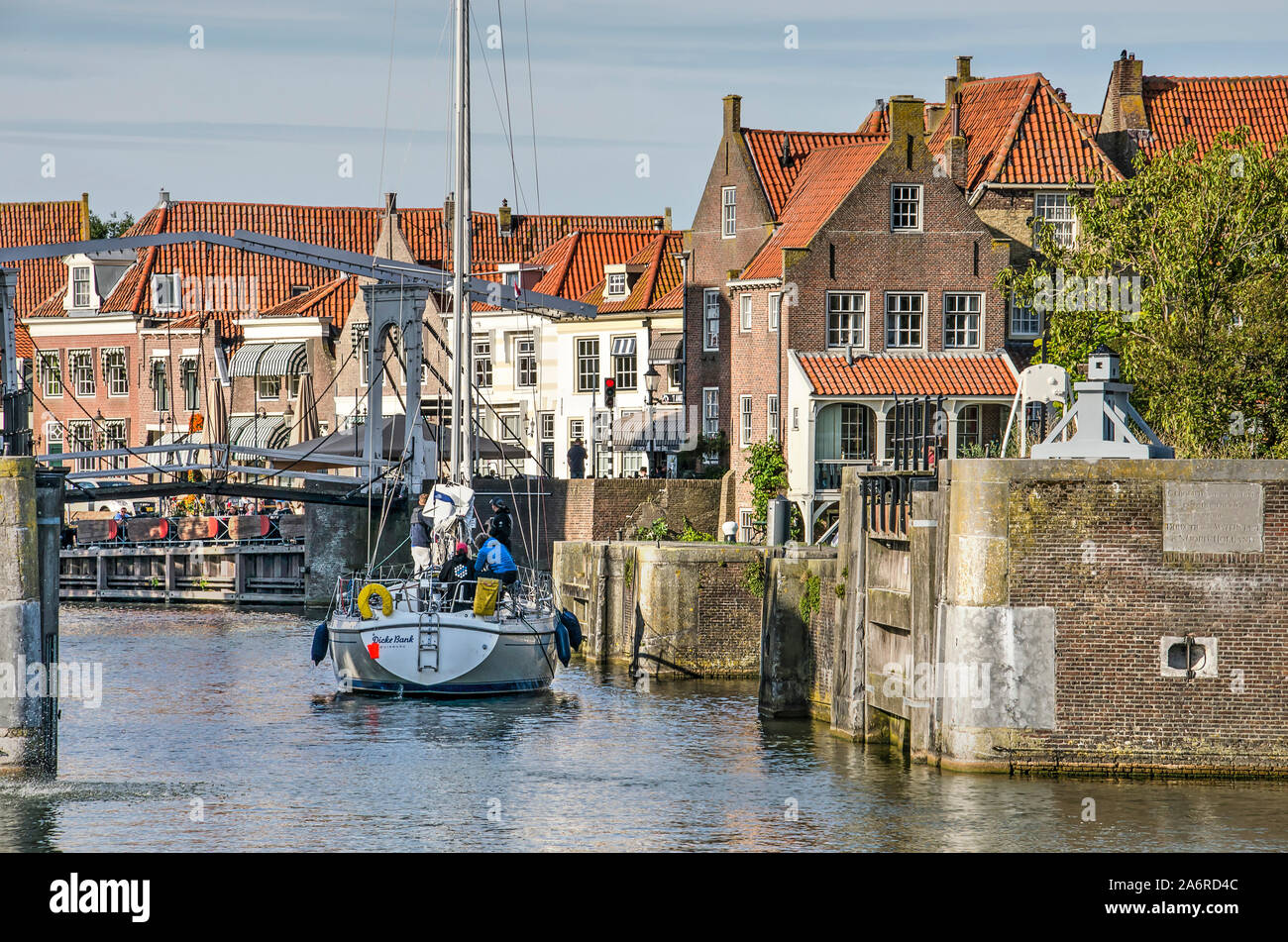 Enkhuizen, The Netherlands, September 13, 2019: motored modern sailing yacht approaching a pedestrian bridge in the old town Stock Photo