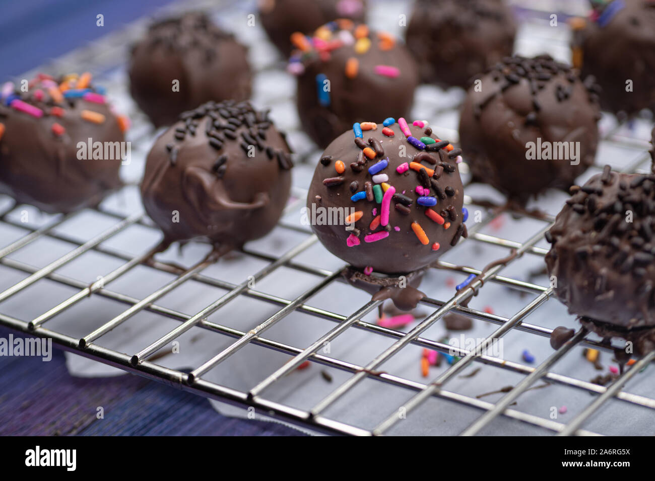 Chocolate donut holes with sprinkles Stock Photo Alamy