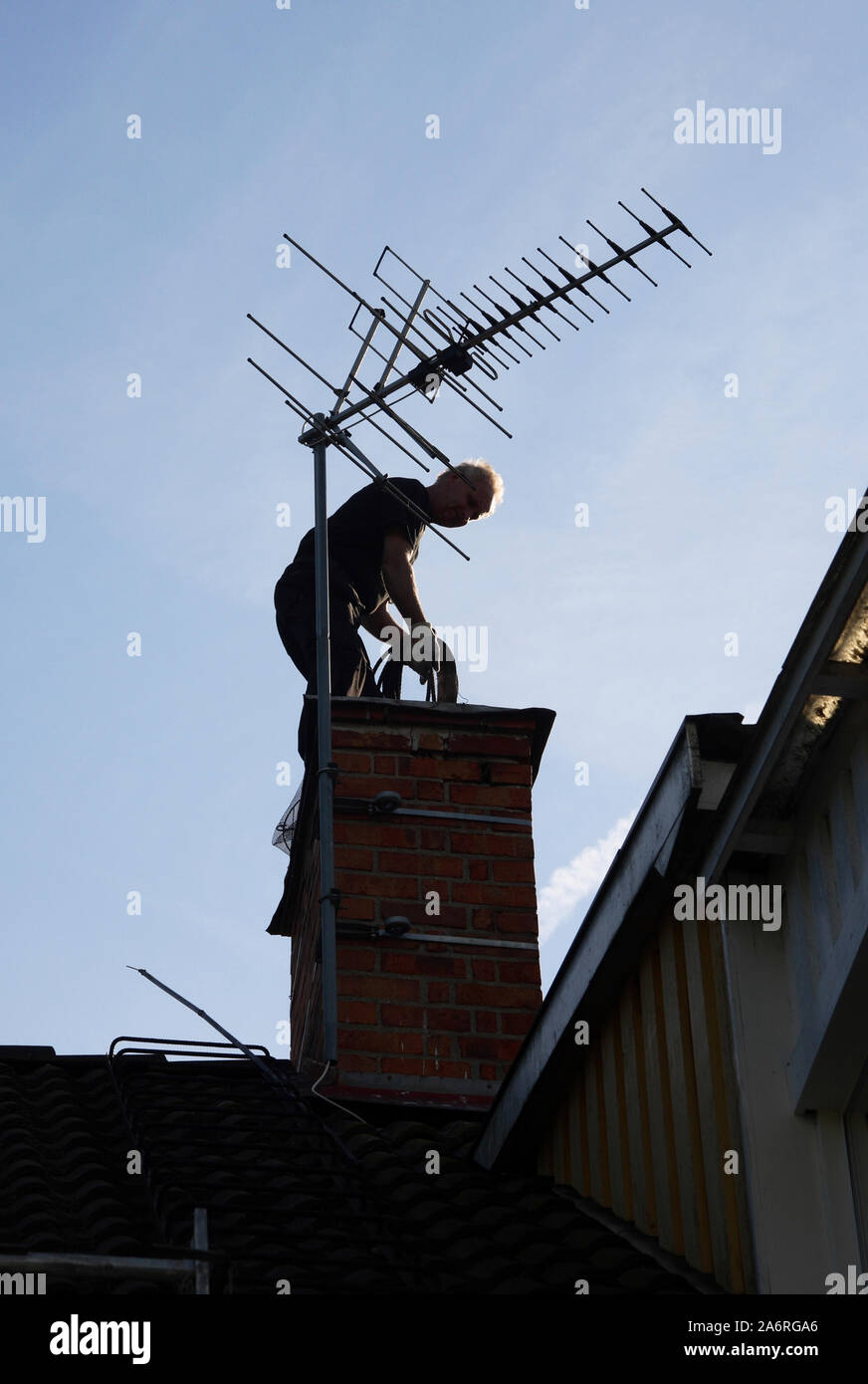 CHIMNEY SWEEP on roof Stock Photo