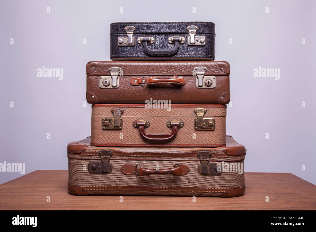 Old, retro, suitcases lie on the table with white background. Obsolete suitcase. Stock Photo