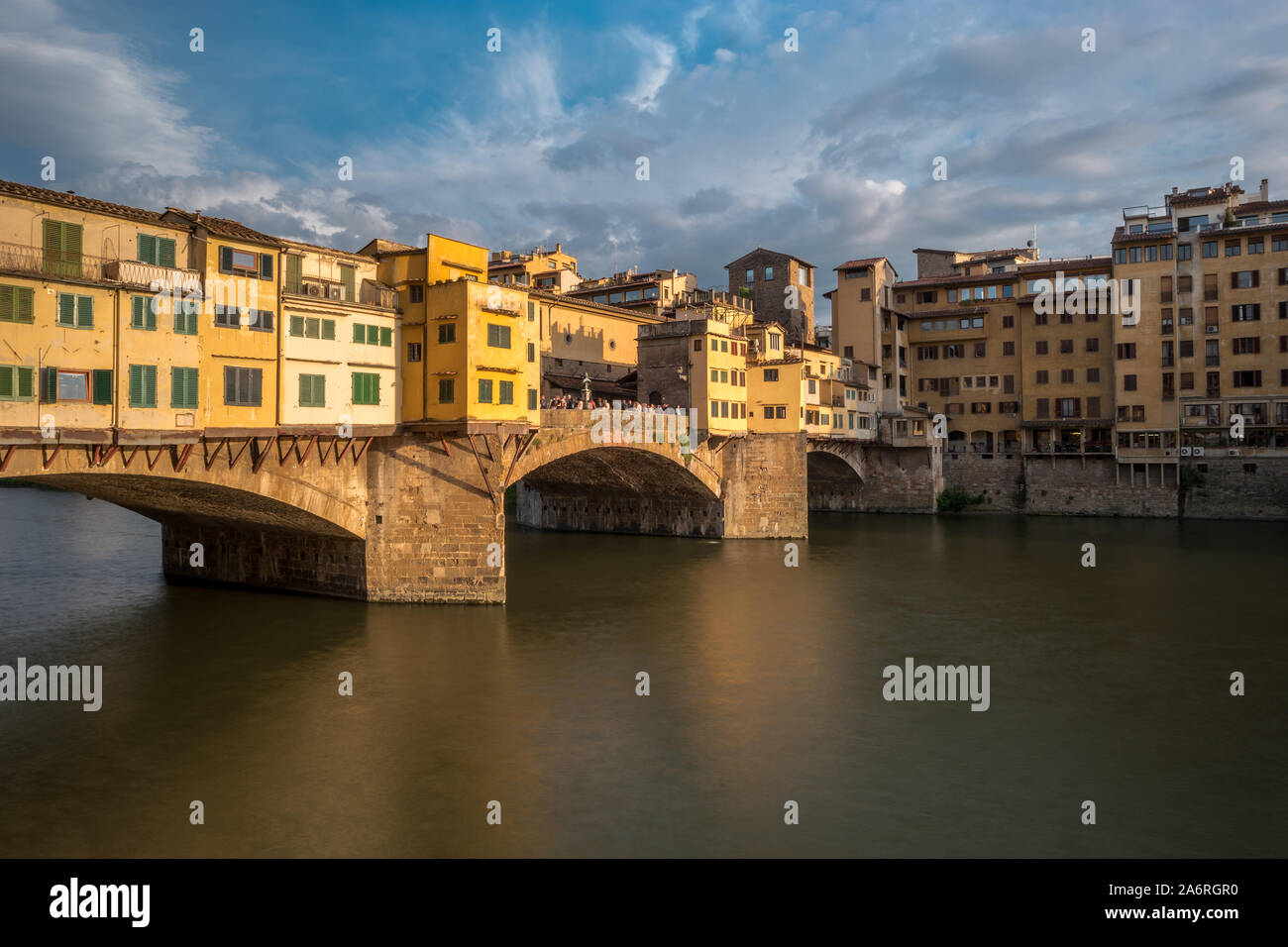 Side view of medieval stone bridge Ponte Vecchio over the Arno River in Florence, Tuscany, Italy. View from the Lungarno degli Archibusieri. Florence is a popular tourist destination of Europe. Stock Photo