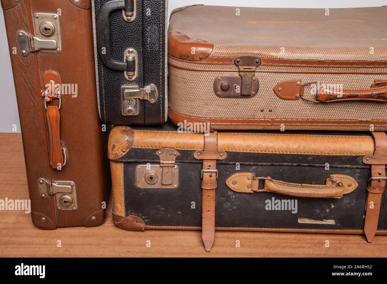 Old, retro, suitcases lie on the table with white background. Obsolete suitcase. Stock Photo