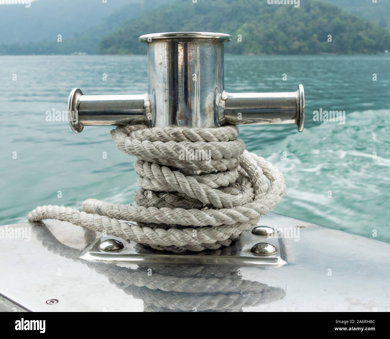 Mooring post on small boat on beautiful green water Stock Photo