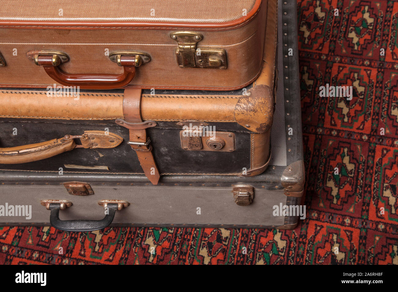 Old, retro, suitcases lie on the table with white background. Obsolete suitcase lying on the carpet Stock Photo