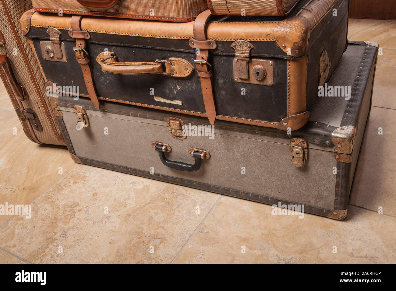 Old, retro, suitcases lie on the table with white background. Obsolete suitcase lying on the floor Stock Photo
