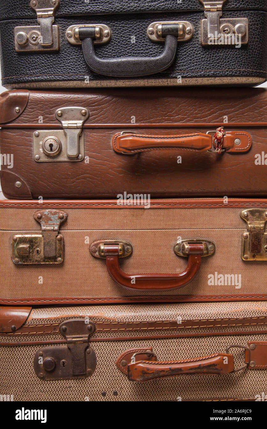 Old, retro, suitcases lie on the table with white background. Obsolete suitcase close up Stock Photo