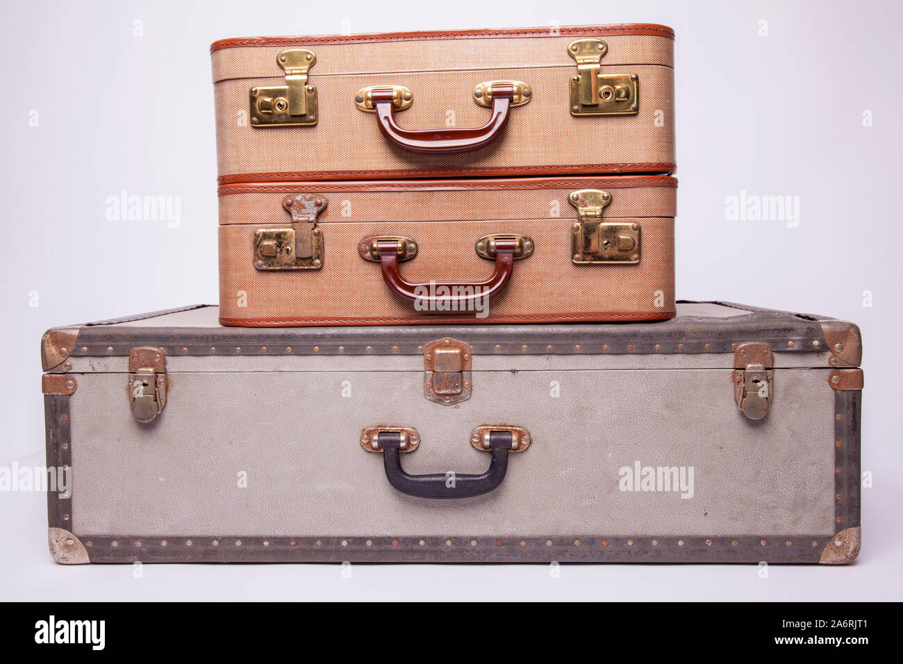 Old, retro, suitcases lie on the table with white background. Obsolete suitcase isolated on white background Stock Photo