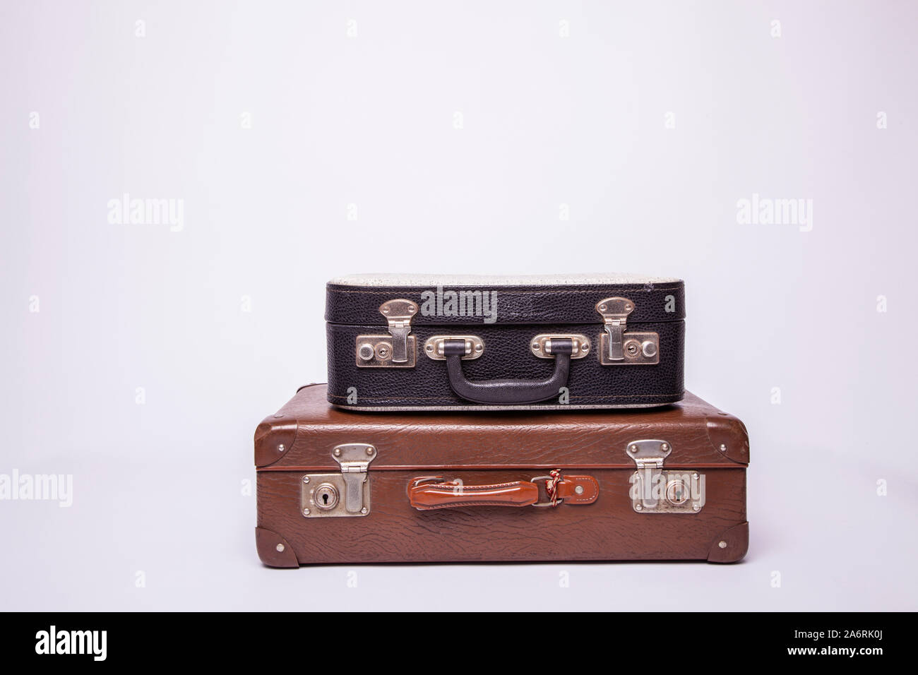 Old, retro, suitcases lie on the table with white background. Obsolete suitcase isolated on white background Stock Photo
