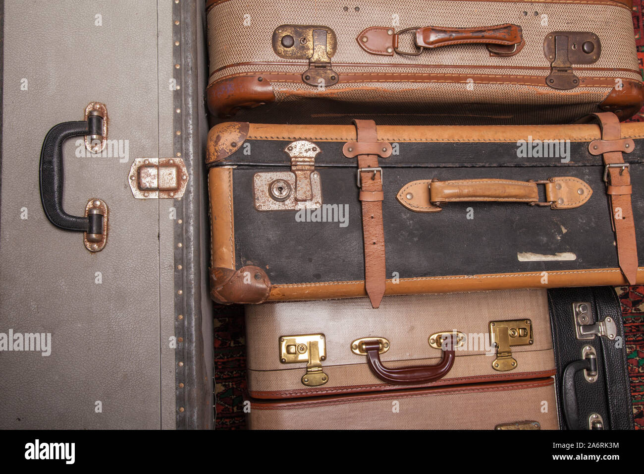 Old, retro, suitcases lie on the table with white background. Obsolete suitcase close up Stock Photo