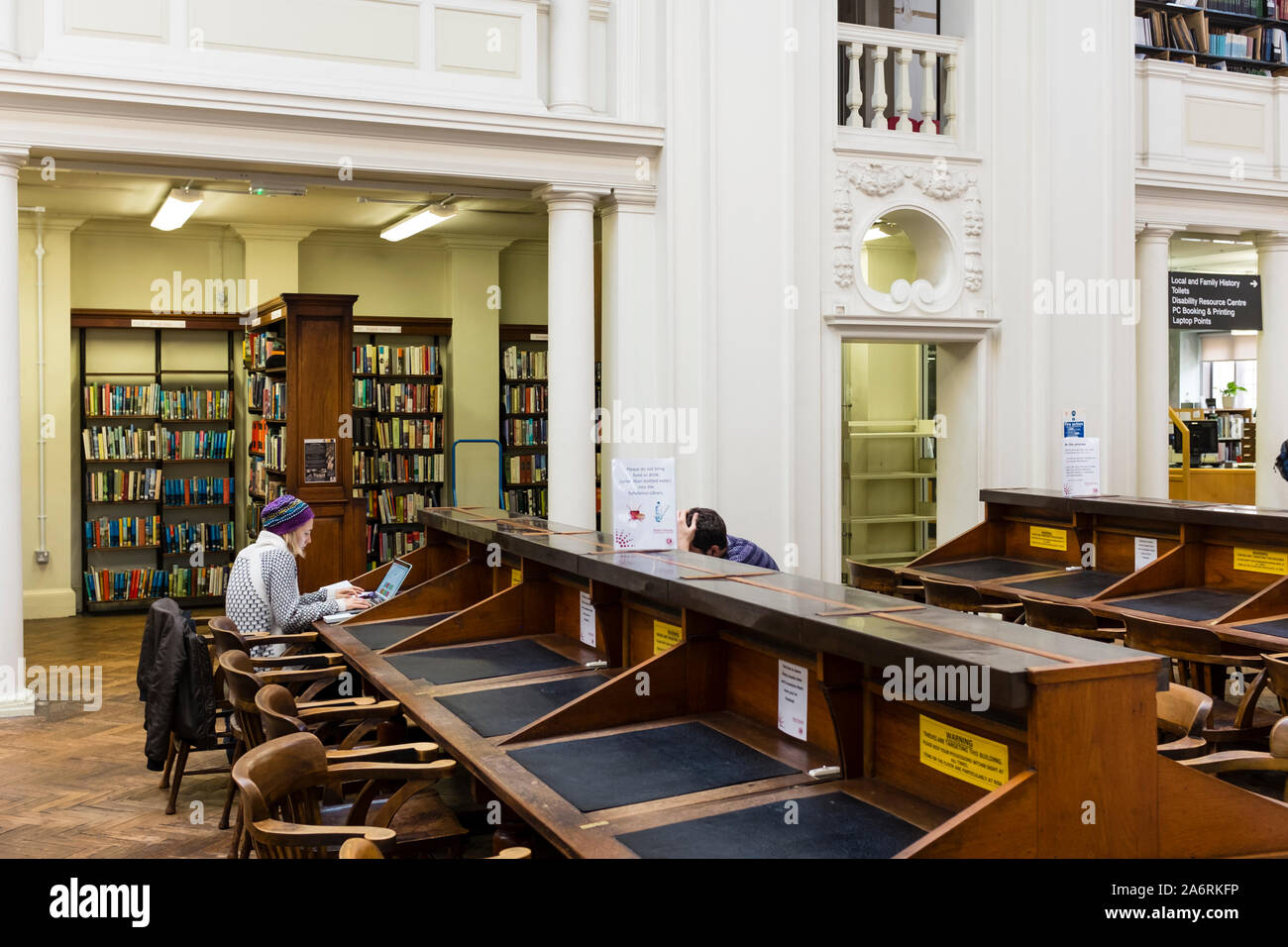 Young students working at desk, Bristol Central Library, UK Stock Photo