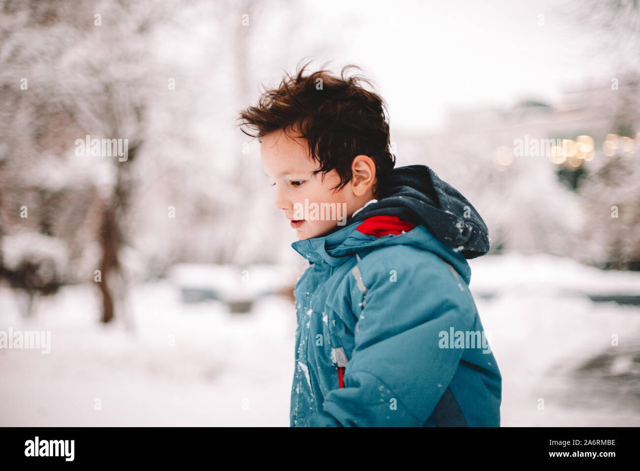 Boy walking in park during winter Stock Photo