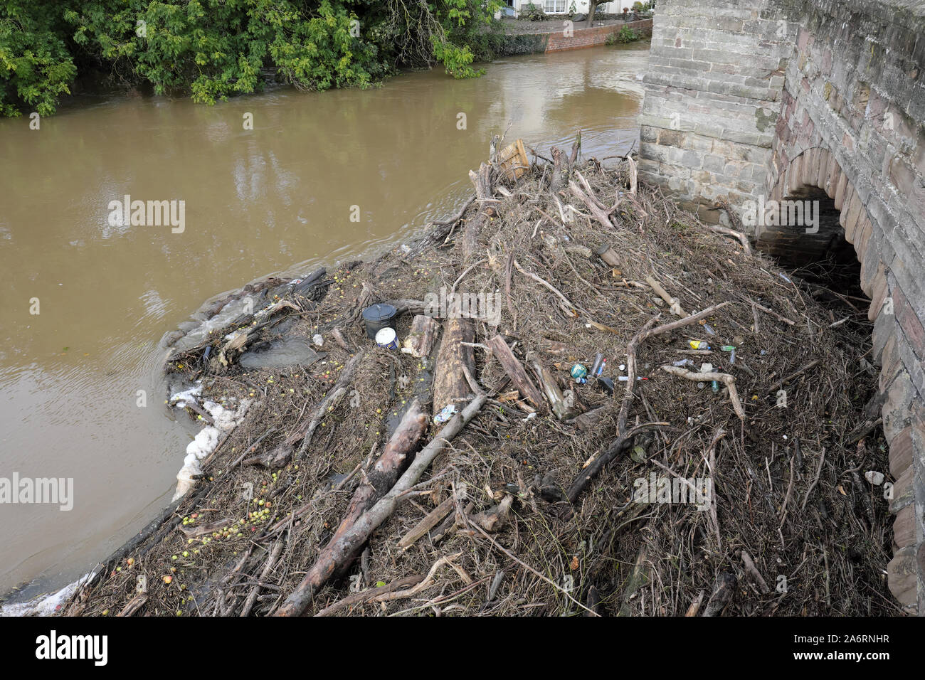 River Wye debris and flotsam blocking an arch span on the old Wye Bridge in Hereford after being washed downstream following very wet weather 2019 Stock Photo