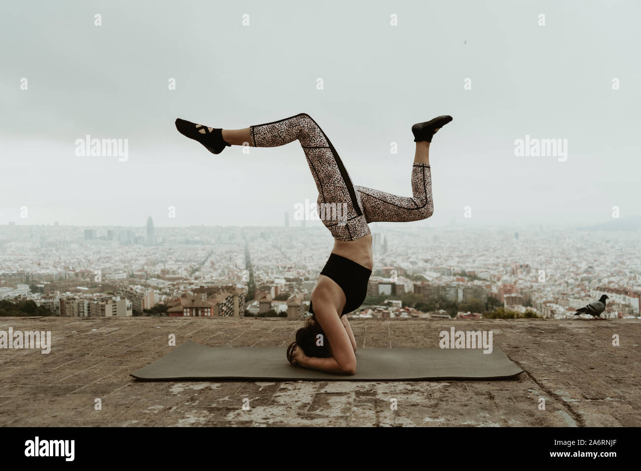 young woman practicing yoga, asana with legs lifted. Barcelona Stock