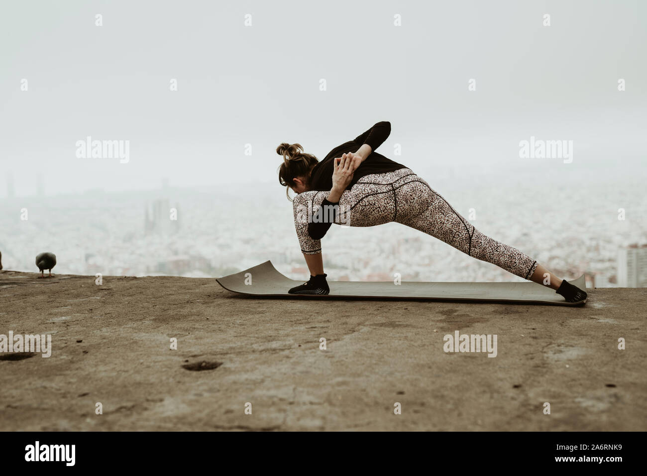 Young woman practicing yoga, stretching.Barcelona Stock Photo