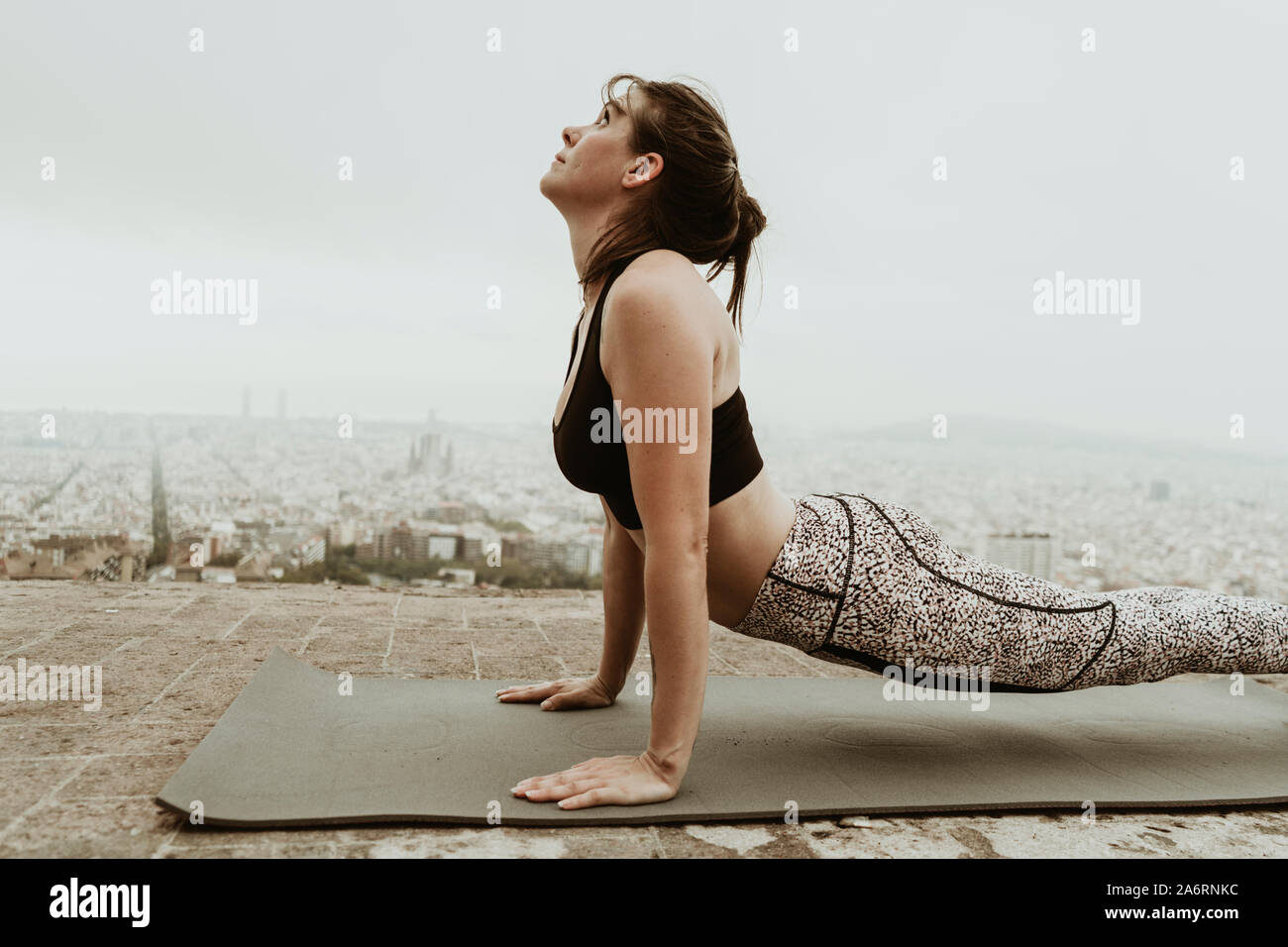 young woman practicing yoga, back stretching. Barcelona Stock Photo