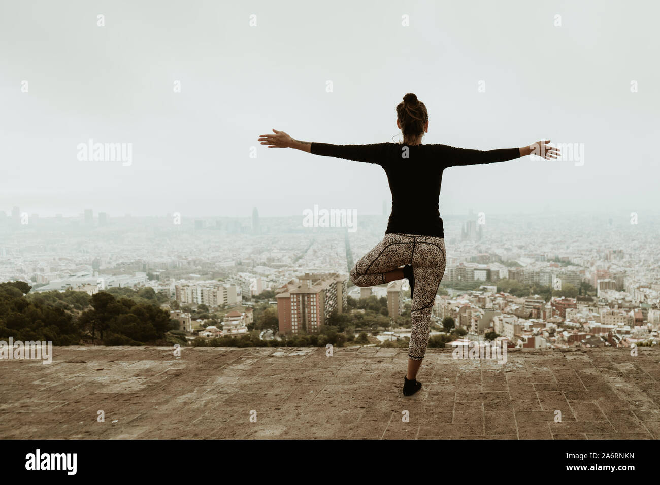 Young woman practicing yoga, asana with arms crossed. Barcelona Stock Photo