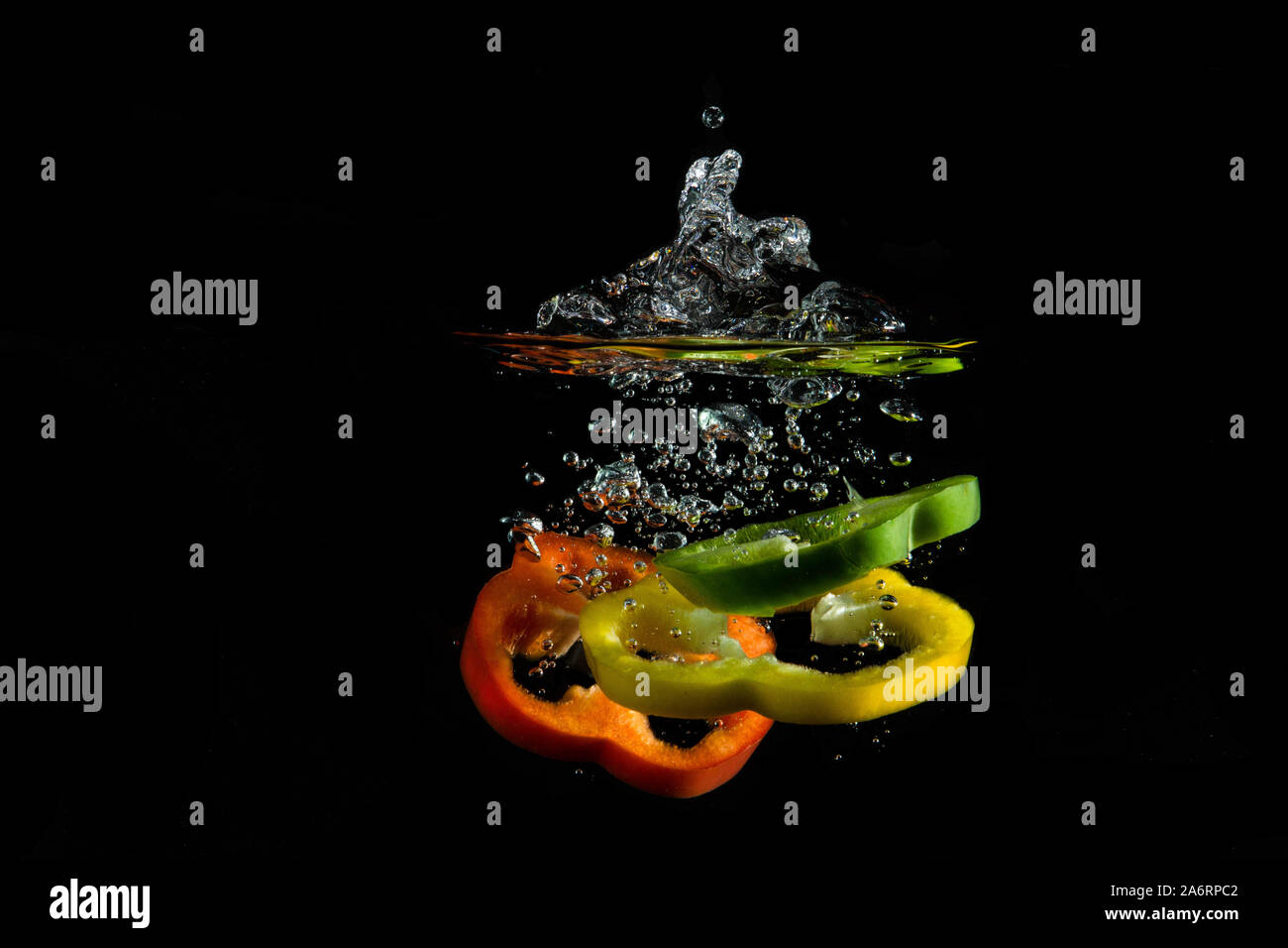 pepper in diferent colours gin vodka splashing water Stock Photo