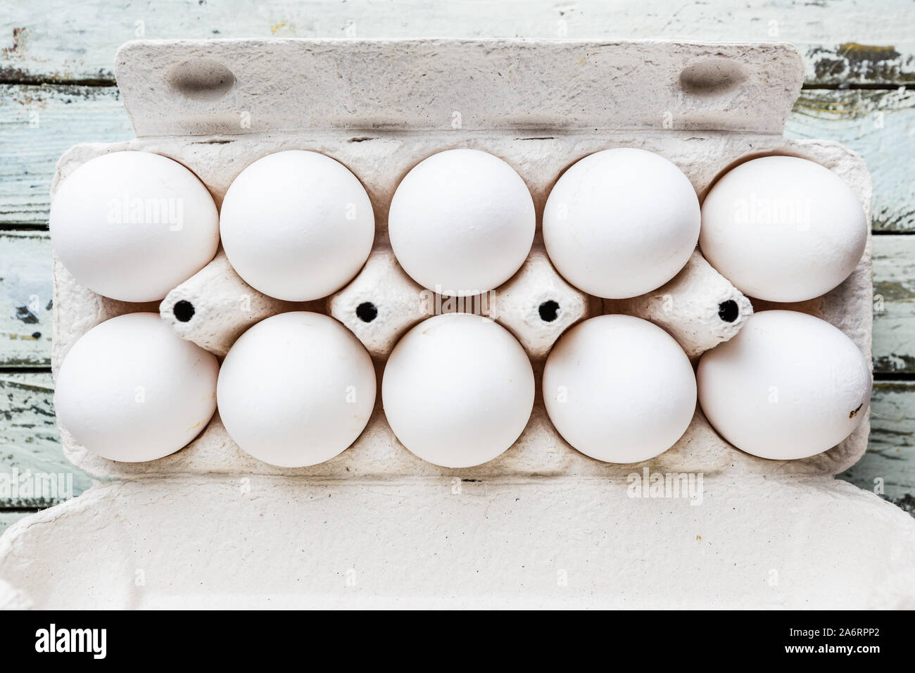 Top view of raw chicken eggs in egg box on white wooden table Stock ...