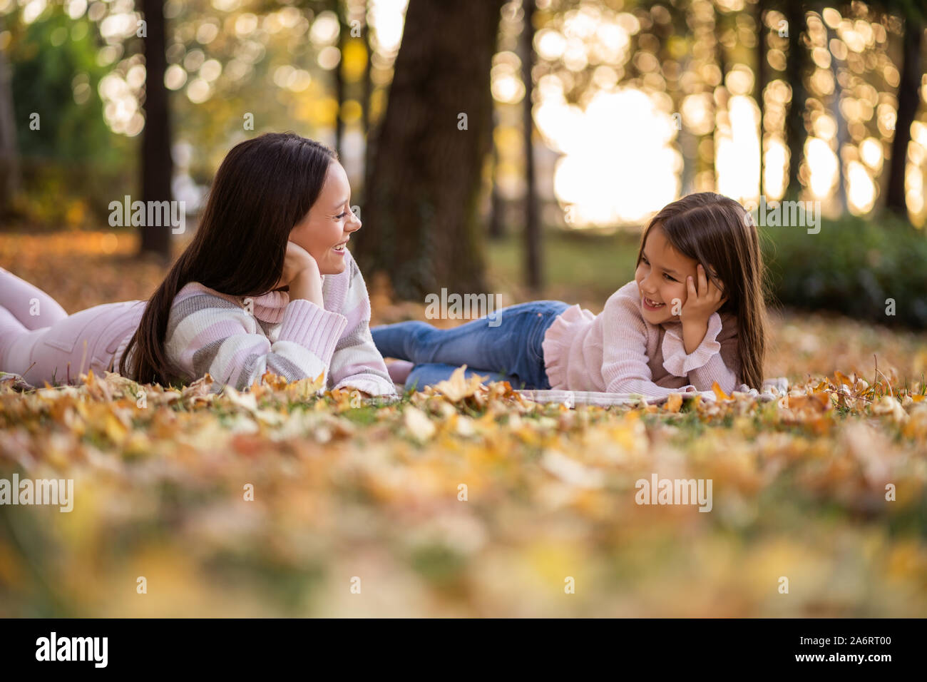 Mother and daughter enjoying autumn in park Stock Photo - Alamy