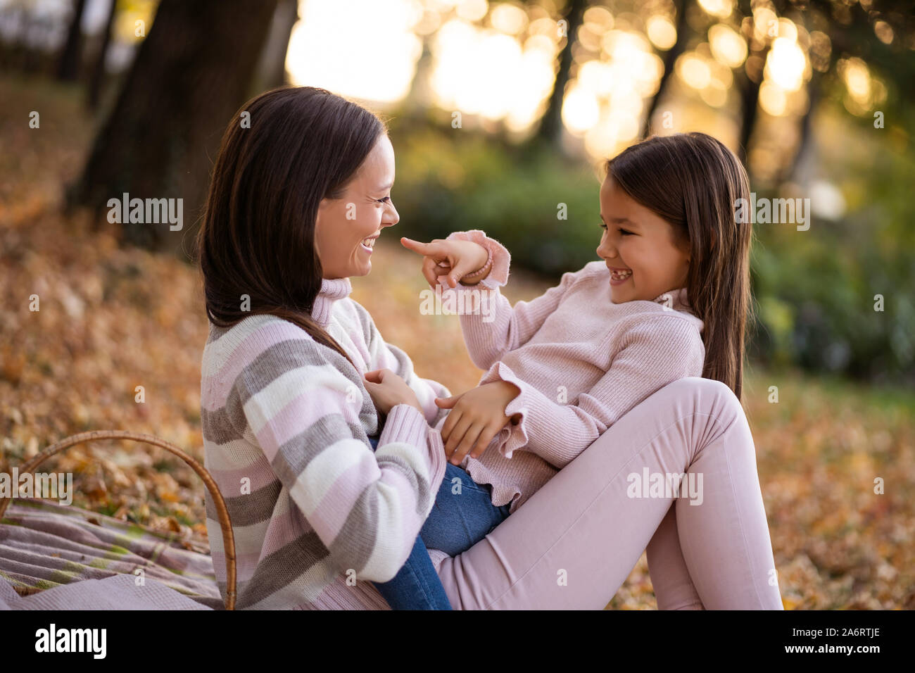 Mother and daughter enjoying autumn in park Stock Photo - Alamy