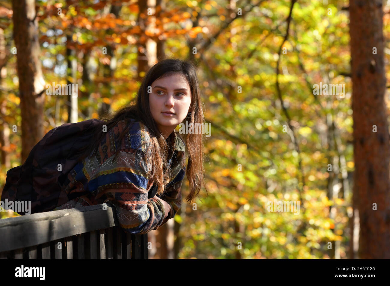 Young girl in autumn forest and Wooden House Stock Photo