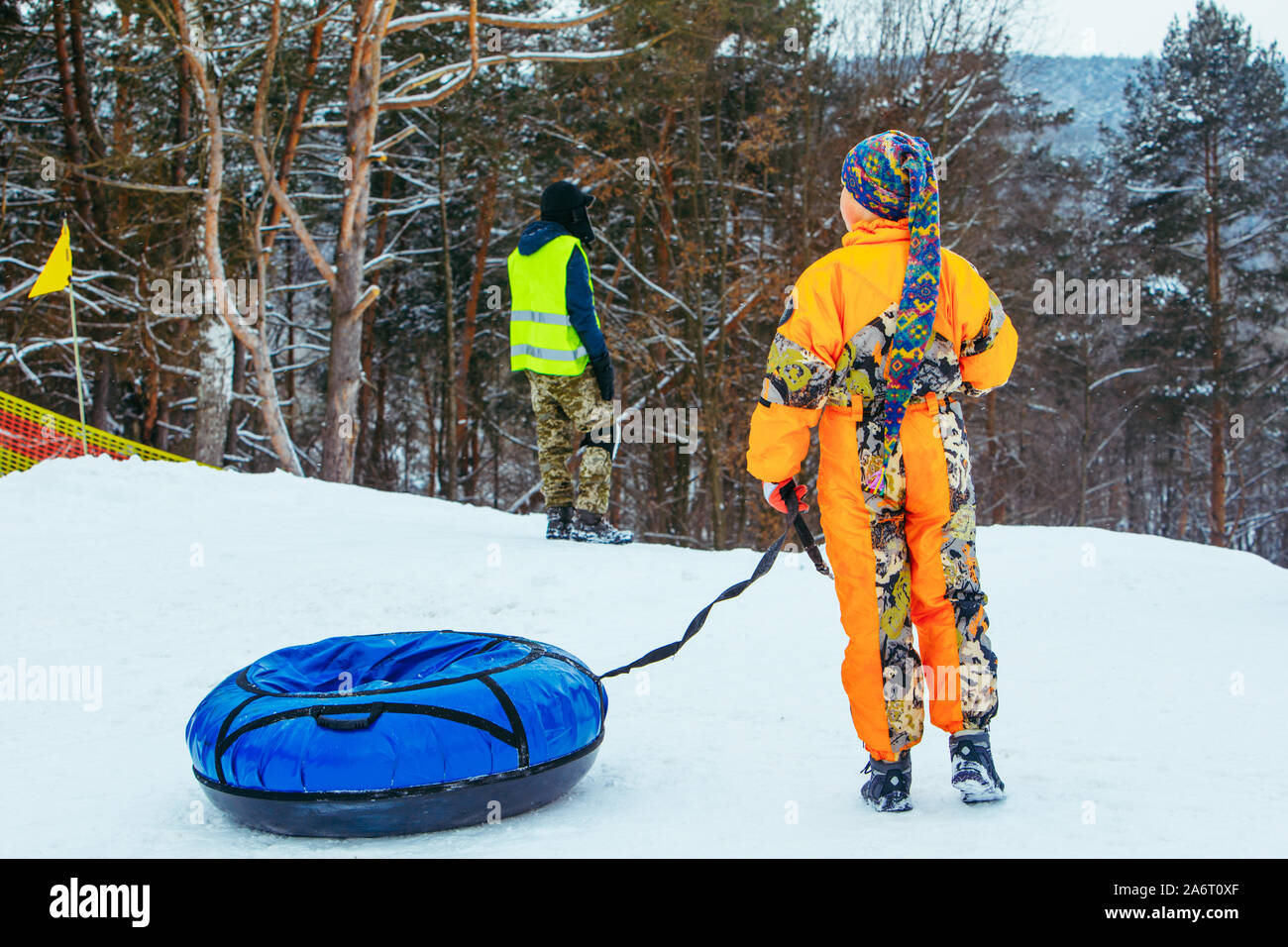 children sliding snow tube down by snowed hill Stock Photo Alamy