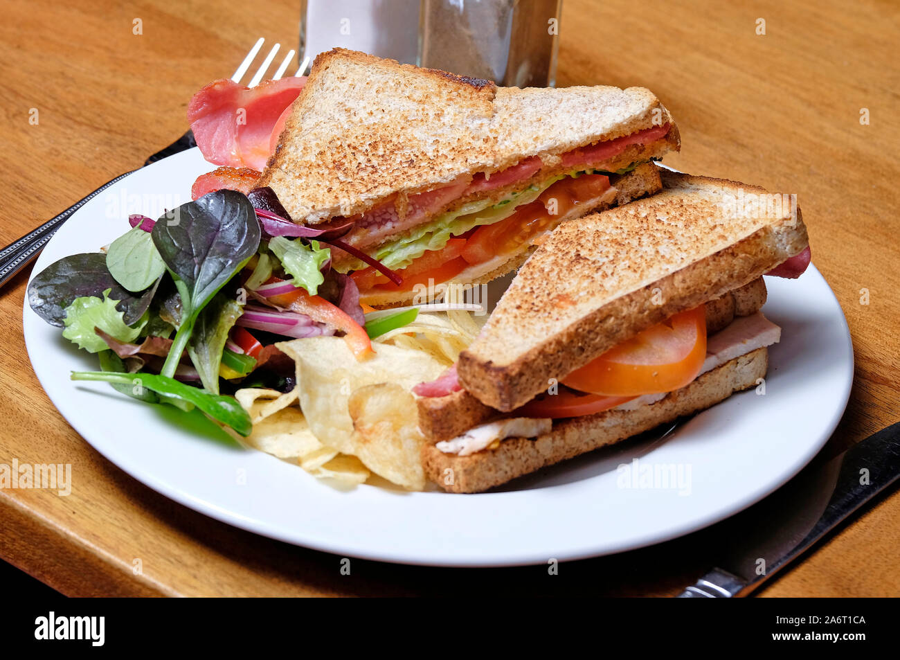 BLT toasted sandwich on white plate Stock Photo