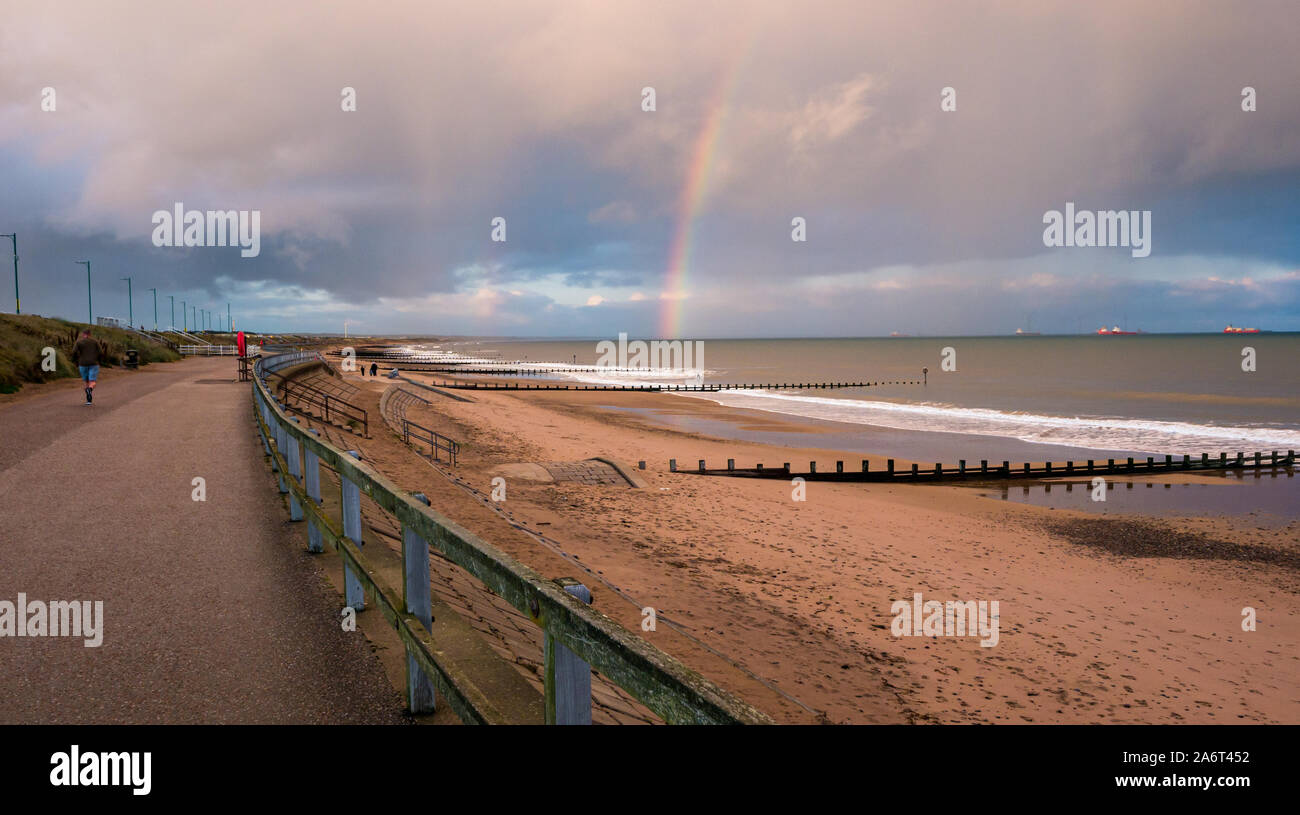 Aberdeen Beach, Aberdeen, Scotland, United Kingdom, 28th October 2019. UK Weather: sunshine and showers in the city cause a bright rainbow at sunset over the North Sea looking towards the wind farm in Aberdeen Bay Stock Photo