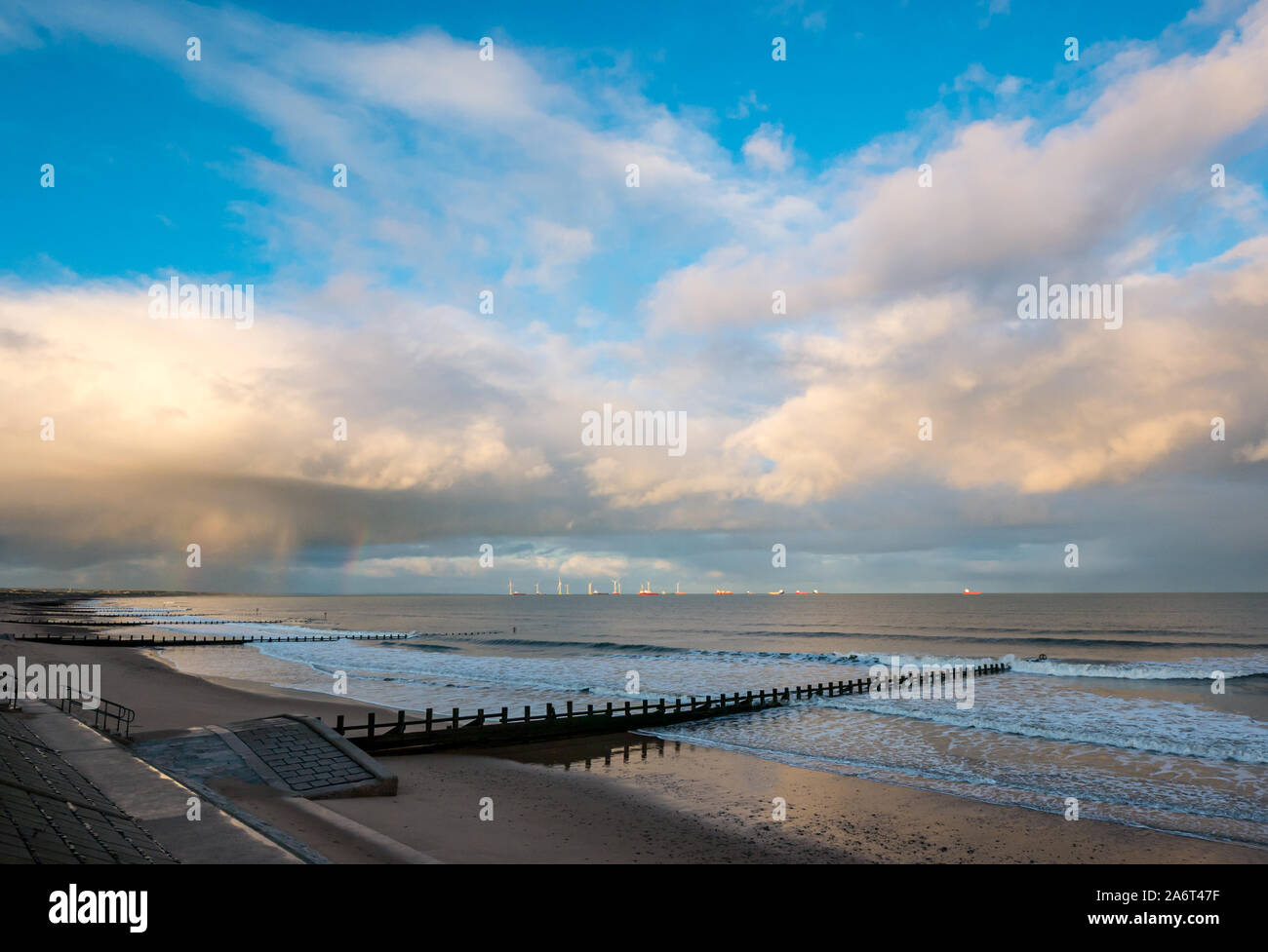 Aberdeen Beach, Aberdeen, Scotland, United Kingdom, 28th October 2019. UK Weather: sunshine and showers in the city cause a bright rainbow at sunset over the North Sea looking towards the wind farm in Aberdeen Bay Stock Photo