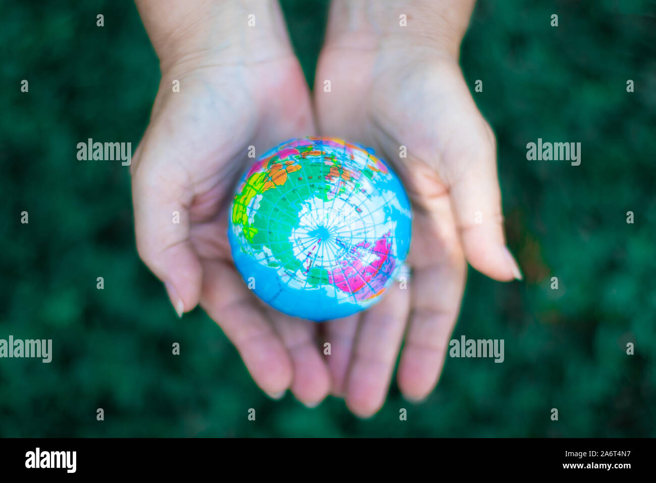 Two hands holding the earth in palm gesture. Ecology concept. Environment Earth Day Stock Photo