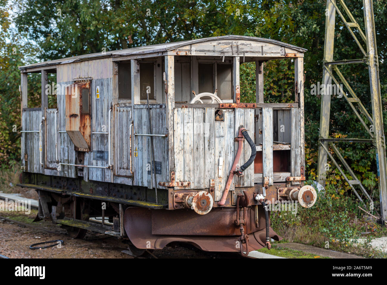 Decaying abandoned old railway guard's van at Shenfield railway station on Greater Anglia line. SHARK large plough brake van. Converted LMS brake van Stock Photo