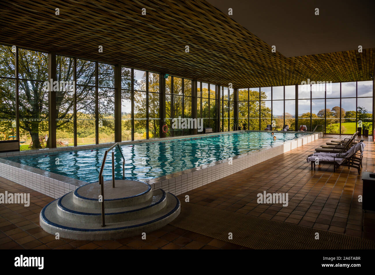 The indoor swimming pool of the five-star Dunloe Hotel & Gardens near Killarney, County Kerry, Ireland, offers guests a view of the surrounding countryside. Stock Photo