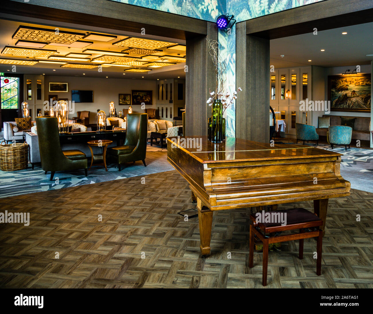 Seating groups with coffee tables define the lounge area of the five-star Dunloe Hotel & Gardens near Killarney, County Kerry, Ireland. Stock Photo