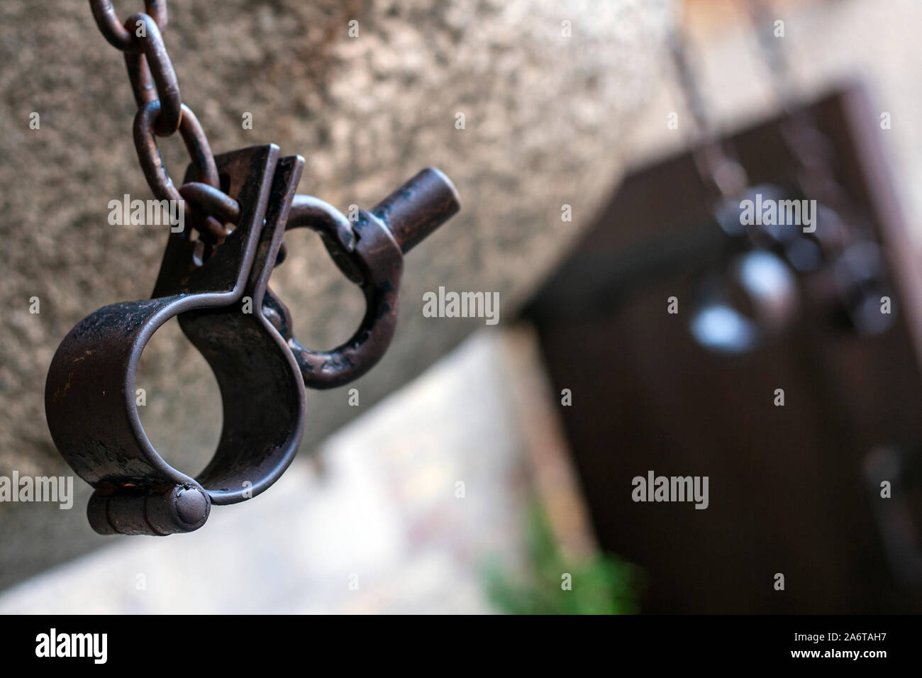 Handcuffs on wall of inside yard of medieval prison tower and torture chamber, today Amber Museum in Gdansk, Poland, Europe Stock Photo