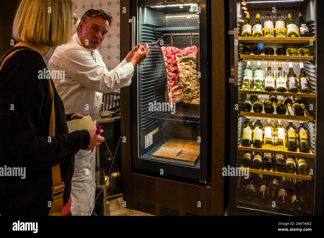 Aged to perfection - Chef Jupp Osterloh in the Dunloe Hotel near Killarney, Ireland. In the entrance area to the restaurant all guests pass the Dry Aging refrigerators Stock Photo