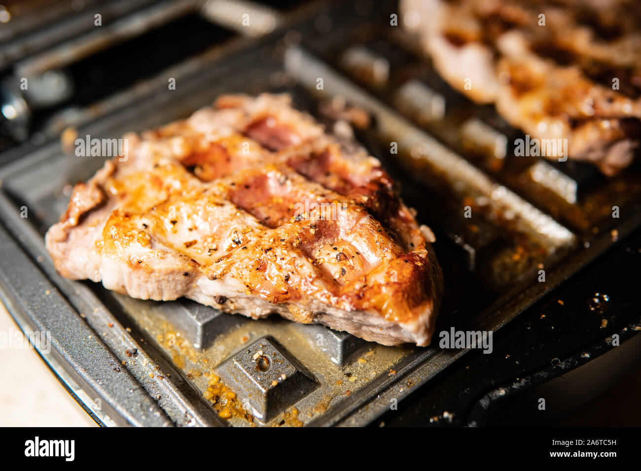 We cook at home barbecue, serve food, glisten grilled meat with fat, cook for the festive table, roast pork Stock Photo